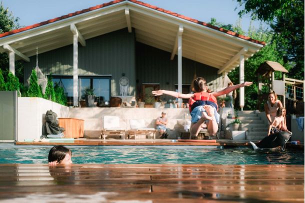 Natural pool in summer with children playing